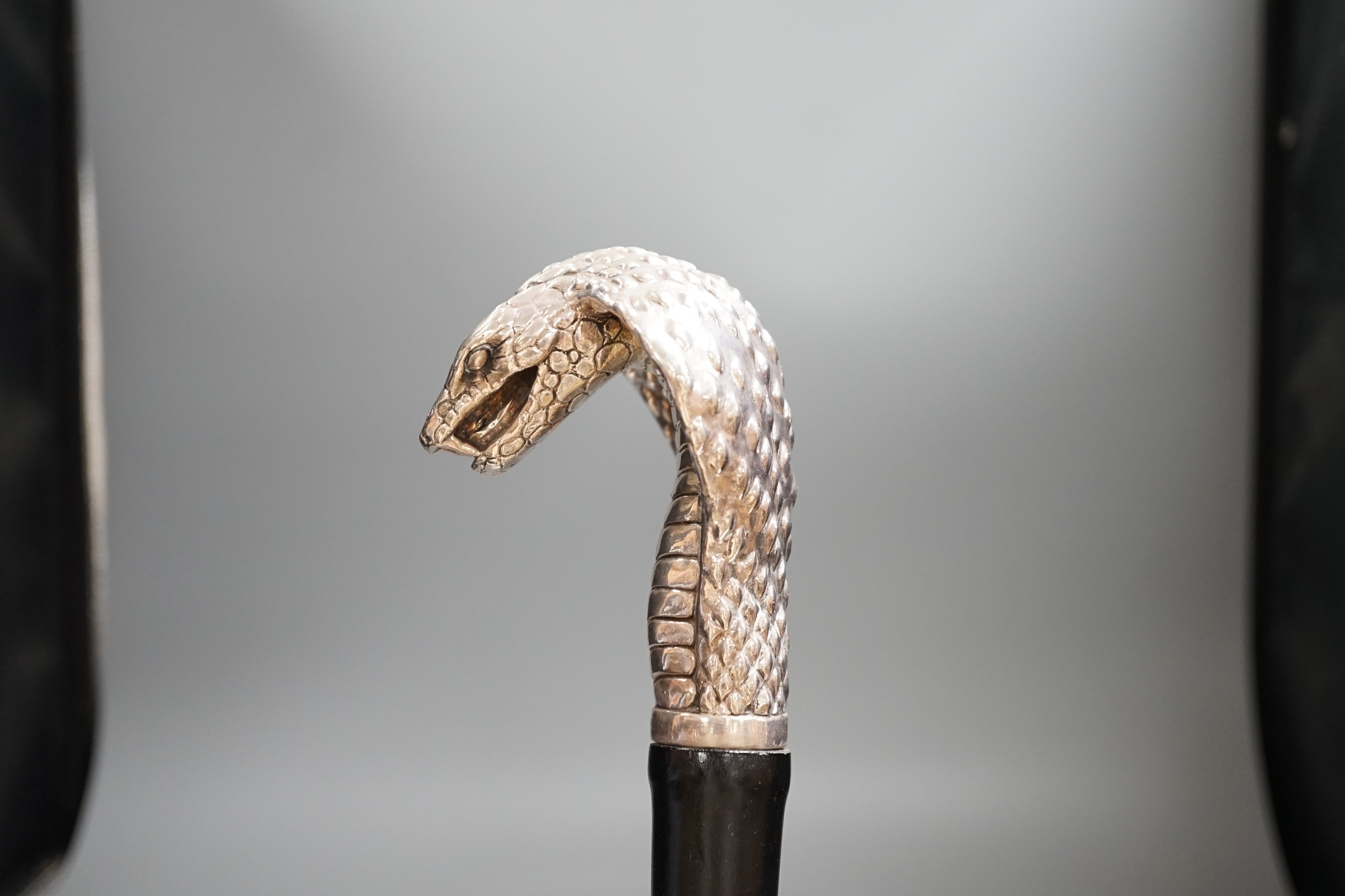 A Jeffery West umbrella with silver cobra handle,94cmslong